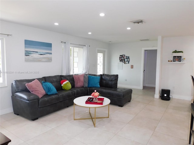 living room featuring recessed lighting, baseboards, and light tile patterned floors