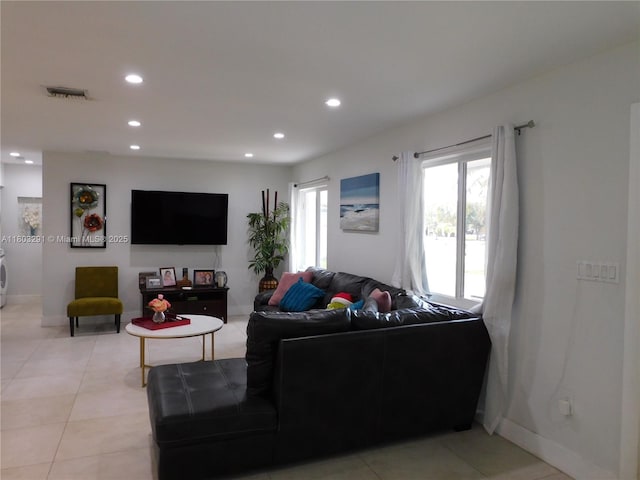 living room with recessed lighting, baseboards, and light tile patterned floors