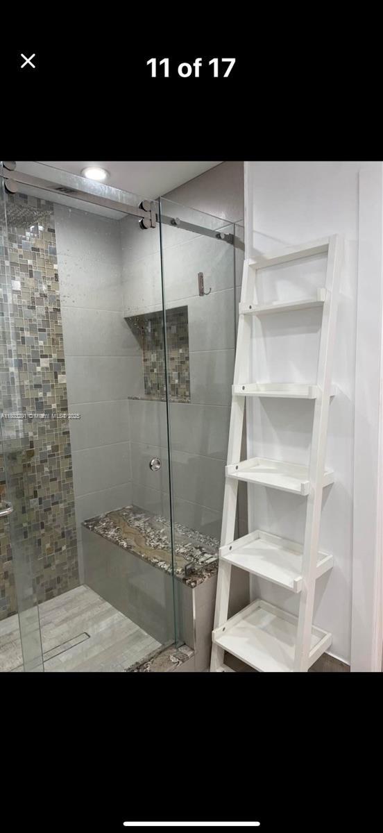 full bath with a shower stall