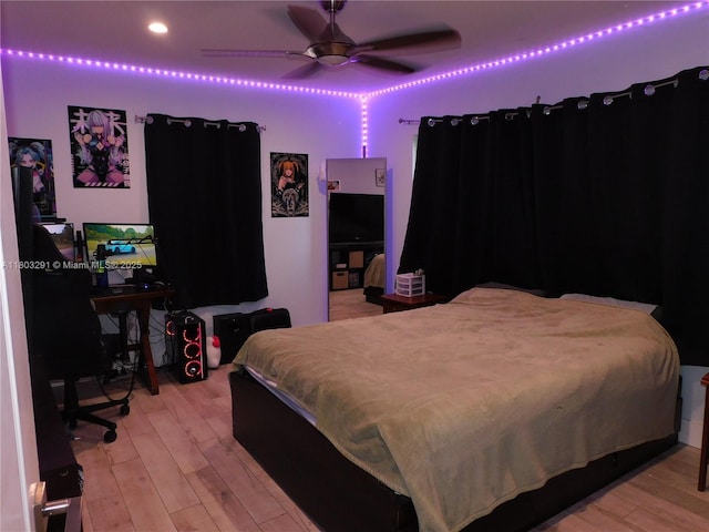 bedroom with light wood-style flooring and ceiling fan