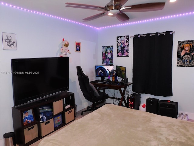bedroom with a ceiling fan and baseboards
