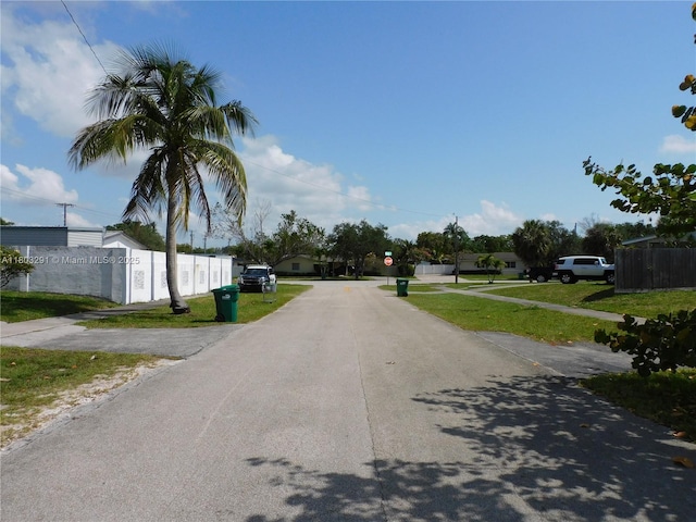 view of asphalt road with traffic signs
