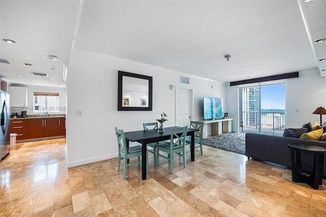 170 SE 14th St Unit 2805, Miami, FL 33131 - dining room featuring crown molding, healthy amount of natural light, and baseboards