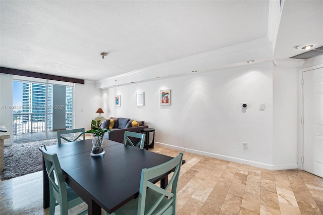 170 SE 14th St Unit 2805, Miami, FL 33131 - dining area featuring a textured ceiling, baseboards, and ornamental molding