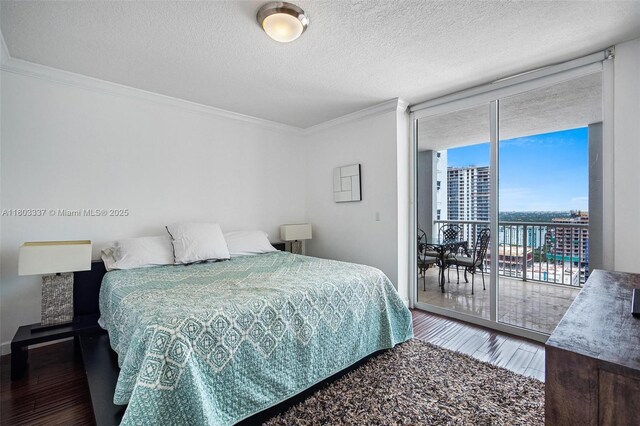170 SE 14th St Unit 2805, Miami, FL 33131 - bedroom with access to exterior, expansive windows, wood finished floors, ornamental molding, and a textured ceiling