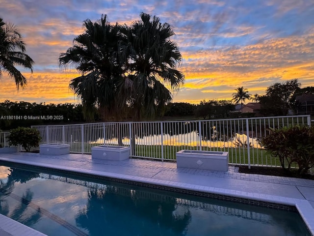 1132 Cedar Falls Dr, Weston, FL 33327 - pool at dusk featuring a patio area