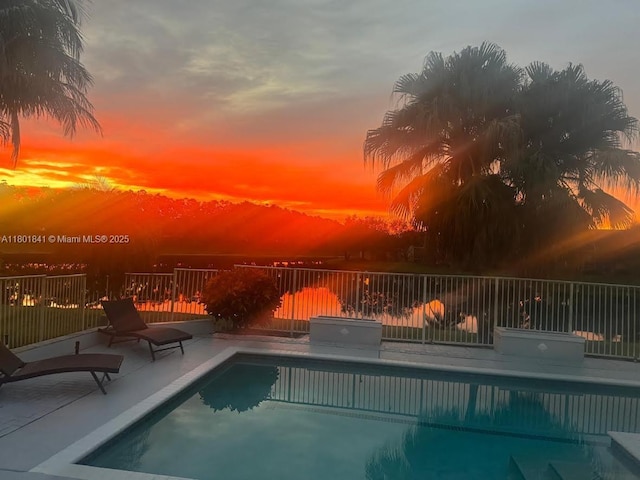 1132 Cedar Falls Dr, Weston, FL 33327 - pool at dusk featuring a patio