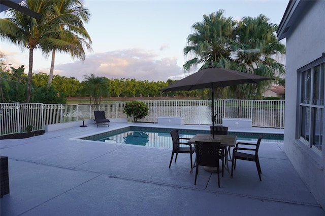 1132 Cedar Falls Dr, Weston, FL 33327 - pool at dusk featuring a patio and a fenced backyard
