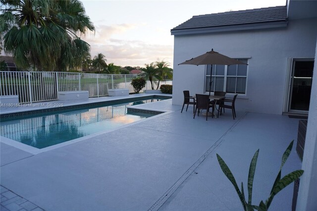 1132 Cedar Falls Dr, Weston, FL 33327 - pool at dusk with a patio