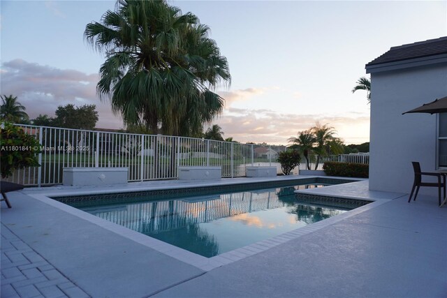 1132 Cedar Falls Dr, Weston, FL 33327 - pool at dusk featuring a patio area