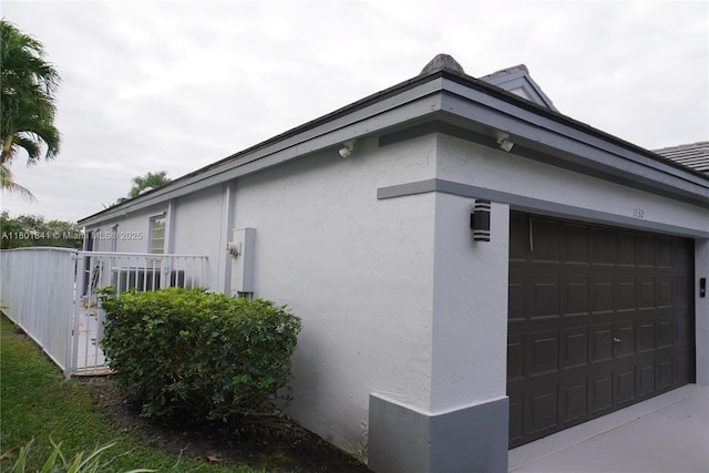 1132 Cedar Falls Dr, Weston, FL 33327 - view of side of home featuring stucco siding and an attached garage