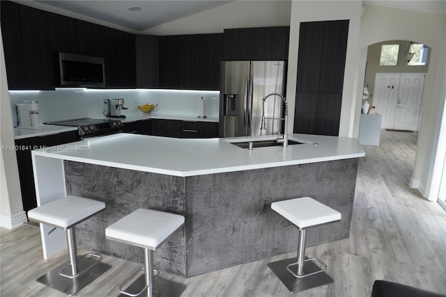1132 Cedar Falls Dr, Weston, FL 33327 - kitchen with stainless steel appliances, a sink, modern cabinets, light countertops, and dark cabinetry
