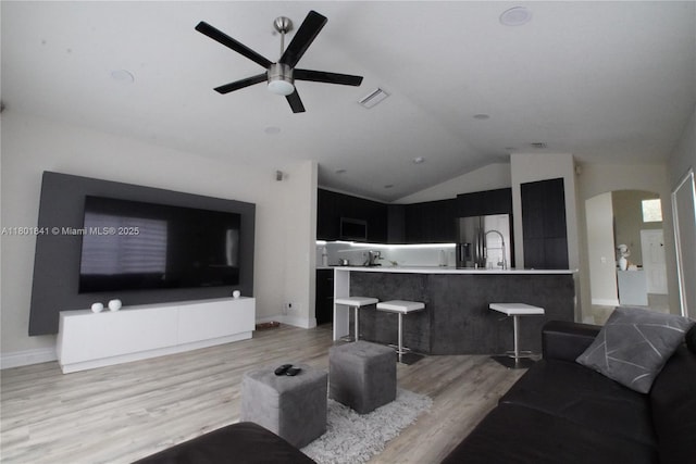 1132 Cedar Falls Dr, Weston, FL 33327 - living area featuring light wood-type flooring, a ceiling fan, lofted ceiling, and arched walkways