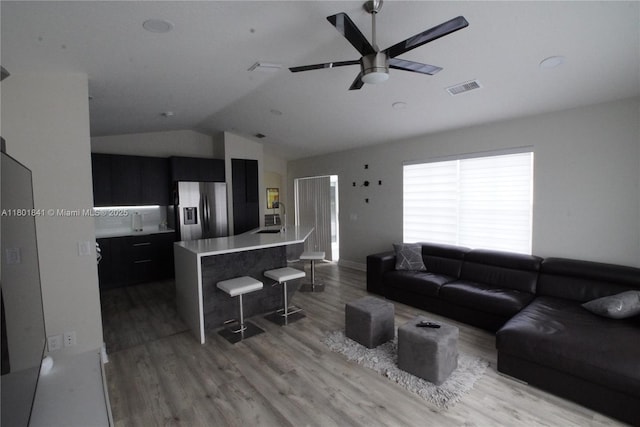 1132 Cedar Falls Dr, Weston, FL 33327 - living room with vaulted ceiling, light wood-style flooring, and a ceiling fan