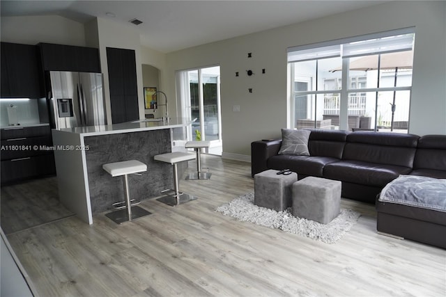 1132 Cedar Falls Dr, Weston, FL 33327 - living room featuring vaulted ceiling, light wood-type flooring, and baseboards