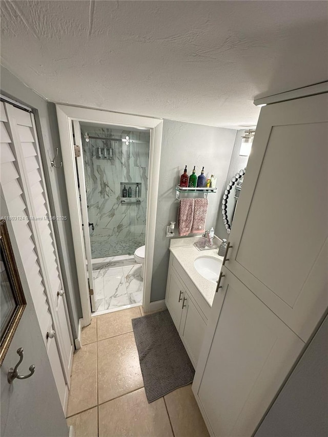 13707 Kendale Lakes Cir Unit 110, Miami, FL 33183 - full bath featuring a marble finish shower, vanity, a textured ceiling, and marble look tiles