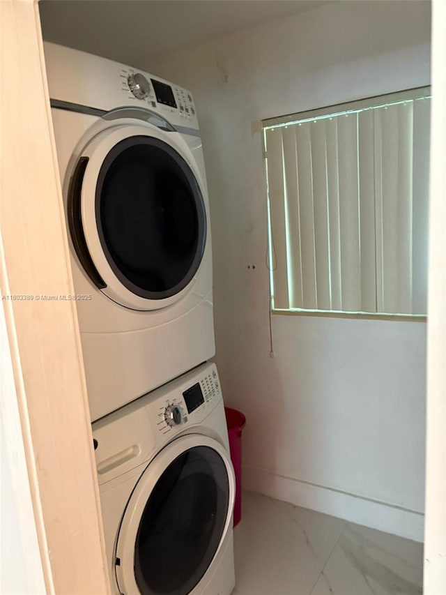 963 Nautilus Isle, Dania Beach, FL 33004 - laundry room with stacked washer / drying machine and marble look tiles