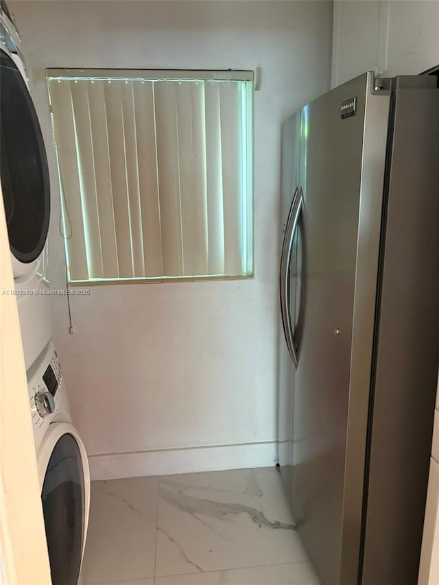 963 Nautilus Isle, Dania Beach, FL 33004 - washroom with stacked washing machine and dryer and marble finish flooring