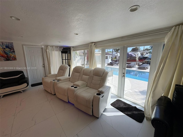 963 Nautilus Isle, Dania Beach, FL 33004 - living room featuring a textured ceiling, marble finish flooring, and french doors