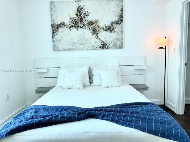 9066 SW 73rd Ct Unit 1703, Miami, FL 33156 - bedroom with baseboards and dark wood-style flooring