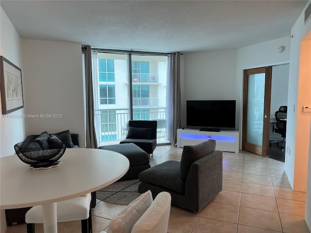 9066 SW 73rd Ct Unit 1703, Miami, FL 33156 - living room featuring light tile patterned floors and a wall of windows