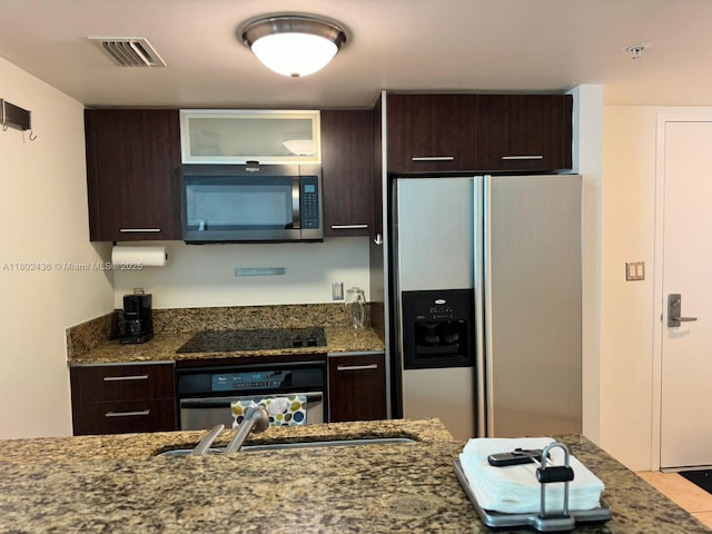 9066 SW 73rd Ct Unit 1703, Miami, FL 33156 - kitchen featuring refrigerator with ice dispenser, stainless steel microwave, dark brown cabinets, wall oven, and dark stone counters