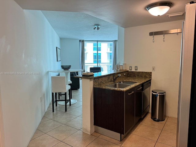 9066 SW 73rd Ct Unit 1703, Miami, FL 33156 - kitchen with a sink, dishwasher, dark stone counters, and light tile patterned floors