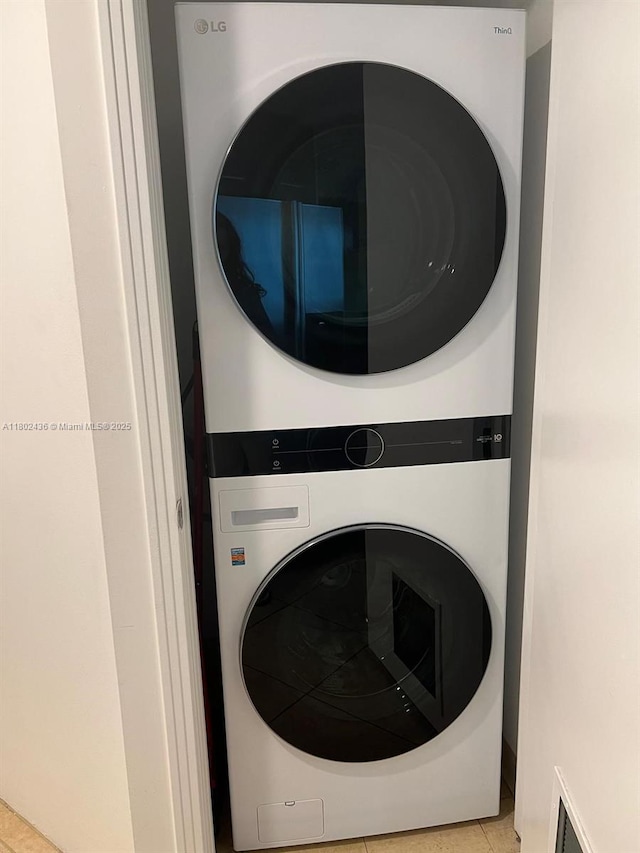 9066 SW 73rd Ct Unit 1703, Miami, FL 33156 - washroom with stacked washer and clothes dryer and tile patterned floors