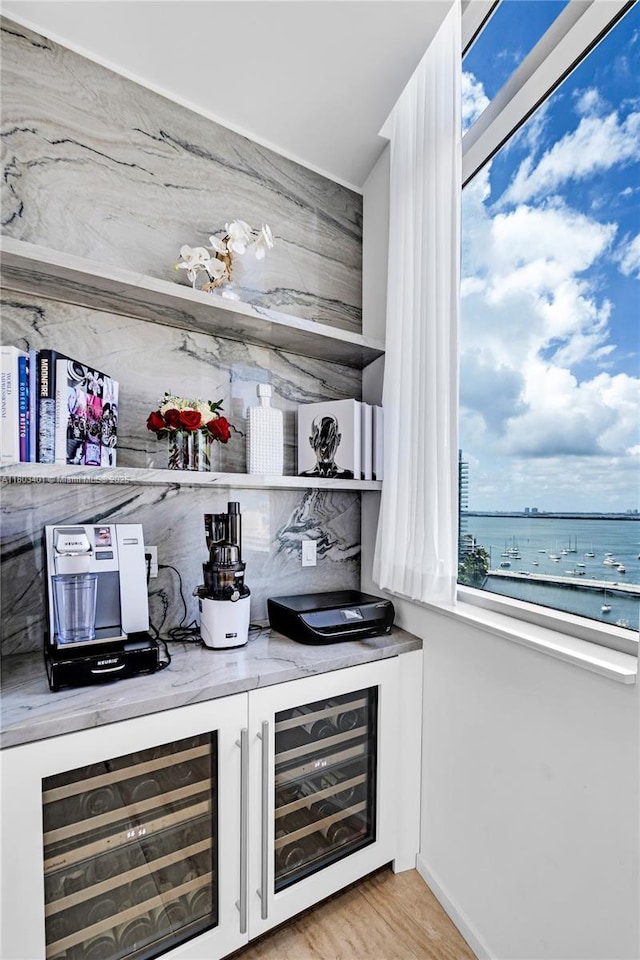 1445 16th St Unit Ph-4, Miami Beach, FL 33139 - indoor bar featuring healthy amount of natural light, wine cooler, and light wood-style flooring