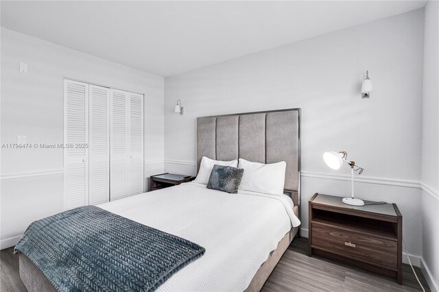 1780 NE 191st St Unit 501-2, Miami, FL 33179 - bedroom featuring wood finished floors, a closet, and baseboards