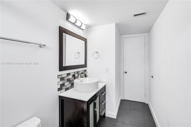 1780 NE 191st St Unit 501-2, Miami, FL 33179 - bathroom with backsplash, vanity, baseboards, toilet, and tile patterned flooring