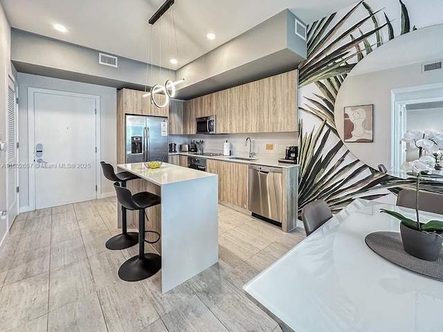 3900 Biscayne Blvd Unit N-819, Miami, FL 33137 - kitchen with appliances with stainless steel finishes, modern cabinets, a kitchen breakfast bar, a center island, and recessed lighting
