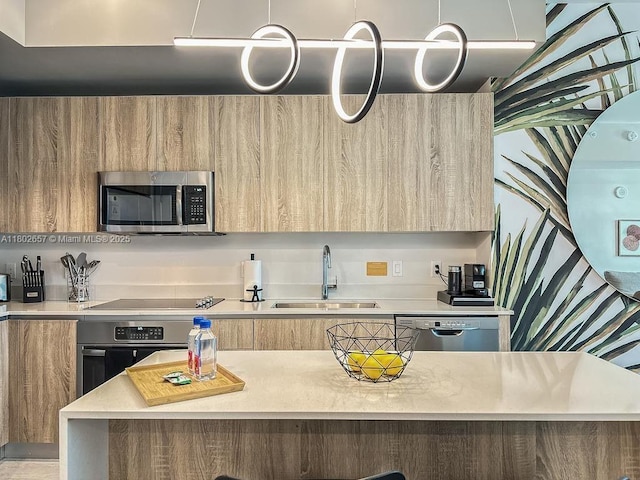 3900 Biscayne Blvd Unit N-819, Miami, FL 33137 - kitchen featuring modern cabinets, appliances with stainless steel finishes, a sink, light countertops, and light brown cabinetry