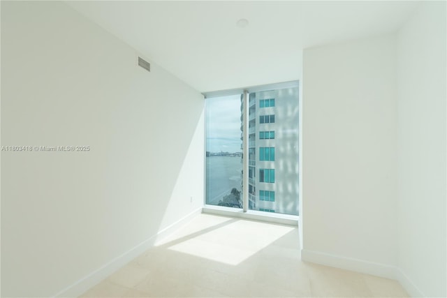 700 NE 26th Ter Unit 903, Miami, FL 33137 - unfurnished room featuring expansive windows and baseboards