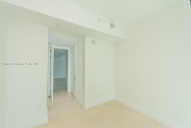 700 NE 26th Ter Unit 903, Miami, FL 33137 - spare room featuring baseboards and a smoke detector