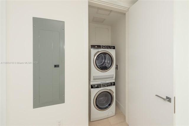 700 NE 26th Ter Unit 903, Miami, FL 33137 - laundry room featuring stacked washer / drying machine, electric panel, light tile patterned flooring, and baseboards