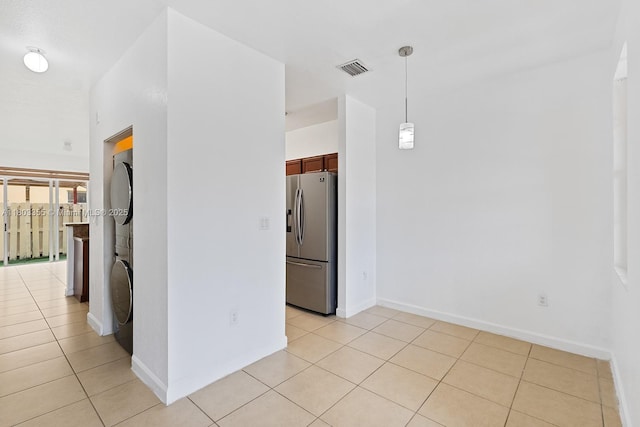 9153 SW 227th St Unit 3, Cutler Bay, FL 33190 - spare room with stacked washer and clothes dryer, light tile patterned floors, and baseboards