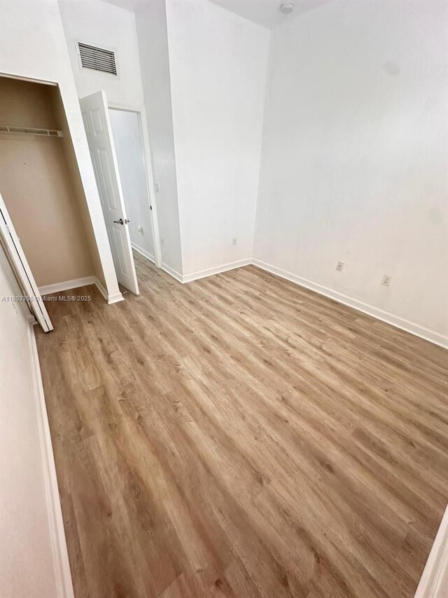 9153 SW 227th St Unit 3, Cutler Bay, FL 33190 - unfurnished bedroom with light wood-style floors, baseboards, and a closet