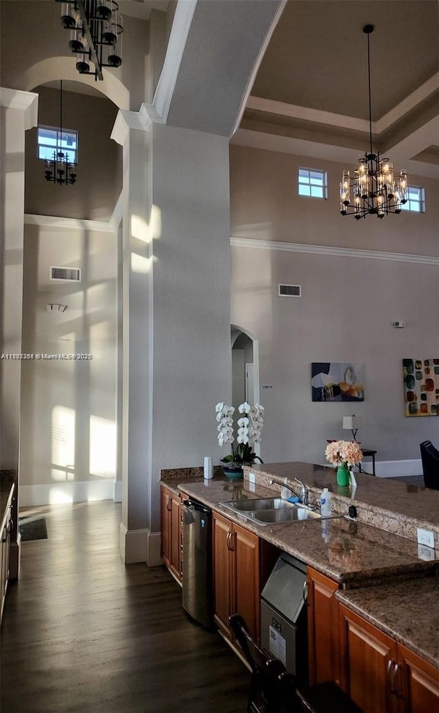 9153 SW 227th St Unit 3, Cutler Bay, FL 33190 - kitchen with a chandelier, a towering ceiling, a sink, brown cabinetry, and dark wood-type flooring