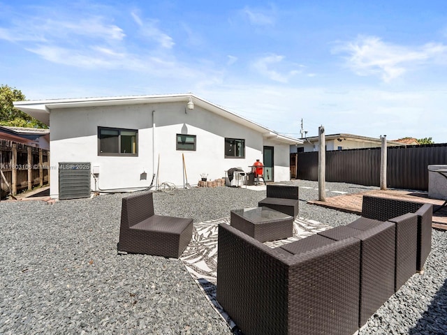 2720 SW 76th Ave, Miami, FL 33155 - back of property featuring an outdoor living space, stucco siding, a fenced backyard, and a patio area