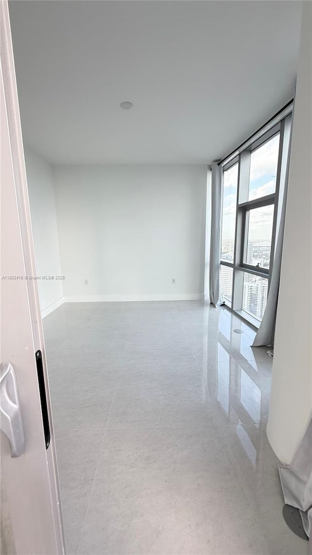 851 NE 1st Ave Unit 3700, Miami, FL 33132 - empty room with floor to ceiling windows and baseboards