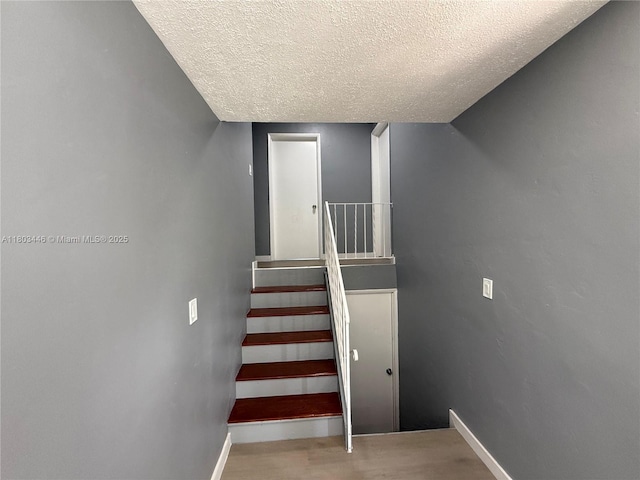 1345 NE 199th St, Miami, FL 33179 - staircase with a textured ceiling, baseboards, and wood finished floors