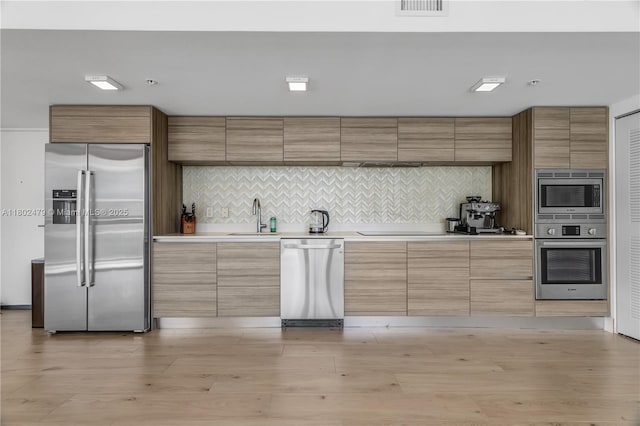 6620 Indian Creek Dr Unit 619, Miami Beach, FL 33141 - kitchen with stainless steel appliances, a sink, light countertops, and decorative backsplash
