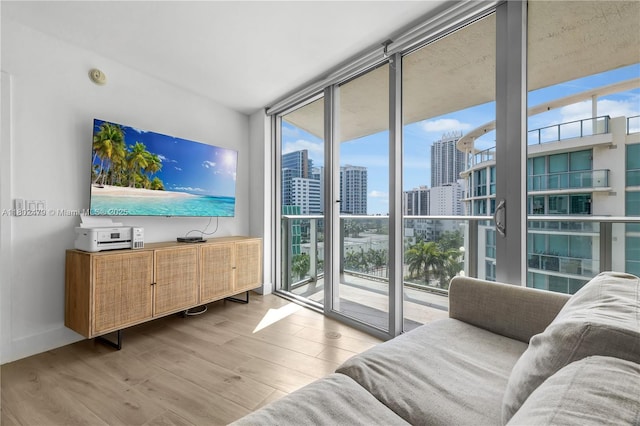 6620 Indian Creek Dr Unit 619, Miami Beach, FL 33141 - living area featuring expansive windows, plenty of natural light, and wood finished floors