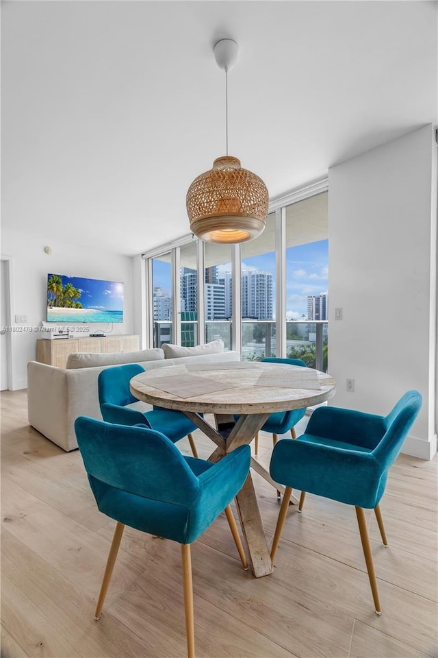 6620 Indian Creek Dr Unit 619, Miami Beach, FL 33141 - dining space featuring light wood-style floors and floor to ceiling windows