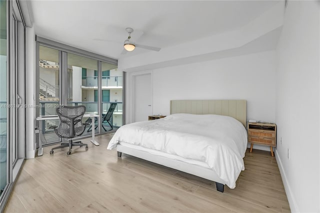6620 Indian Creek Dr Unit 619, Miami Beach, FL 33141 - bedroom featuring wood finished floors, baseboards, ceiling fan, and a wall of windows