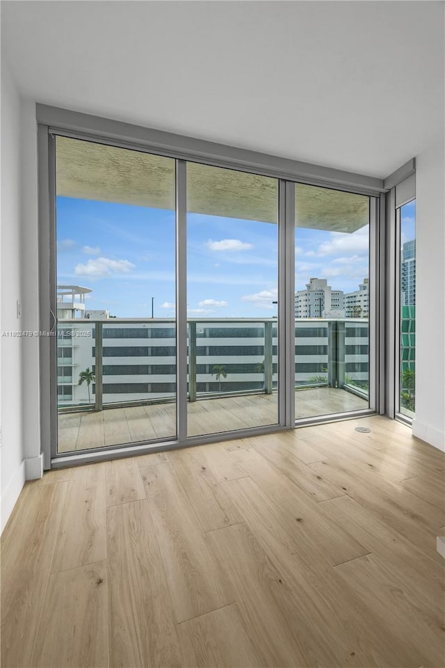 6620 Indian Creek Dr Unit 619, Miami Beach, FL 33141 - empty room with wood finished floors, expansive windows, and baseboards