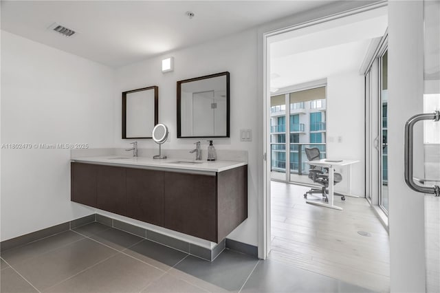 6620 Indian Creek Dr Unit 619, Miami Beach, FL 33141 - bathroom featuring baseboards and double vanity