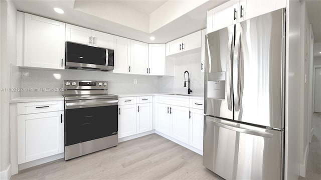 5531 SW 38th St, West Park, FL 33023 - kitchen featuring appliances with stainless steel finishes, a sink, light countertops, white cabinetry, and recessed lighting