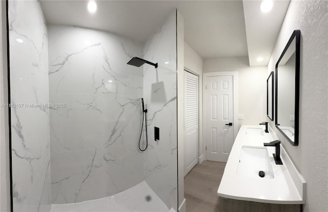 5531 SW 38th St, West Park, FL 33023 - full bathroom with a marble finish shower, double vanity, recessed lighting, and wood finished floors